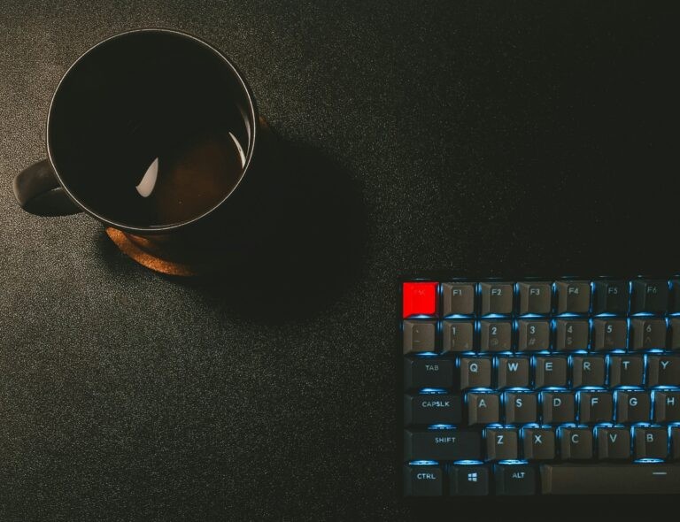 Half a keyboard with a coffee mug